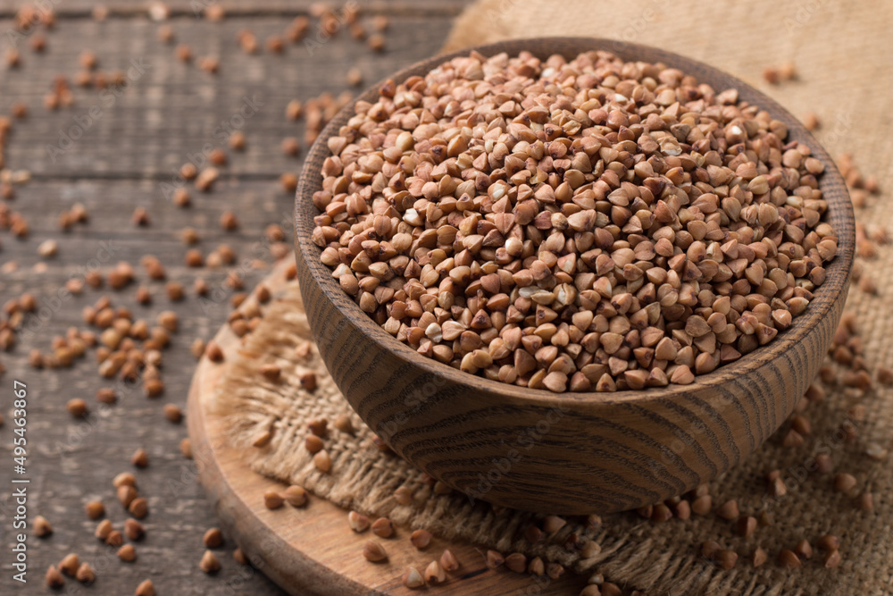 Buckwheat groats on wooden background. Healthy cereal concept. Buckwheat groats on wooden background. Healthy cereal concept.