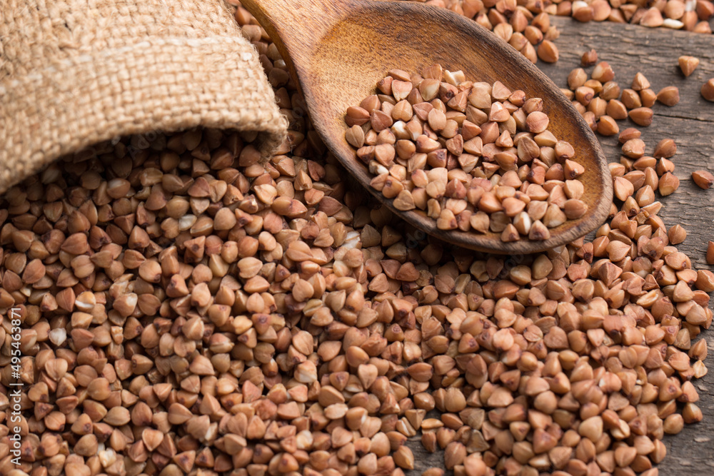 Buckwheat groats on wooden background. Healthy cereal concept. Buckwheat groats on wooden background. Healthy cereal concept.
