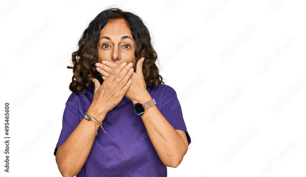 Middle age hispanic woman wearing casual clothes shocked covering mouth with hands for mistake. secret concept. Middle age hispanic woman wearing casual clothes shocked covering mouth with hands for mistake. secret concept.