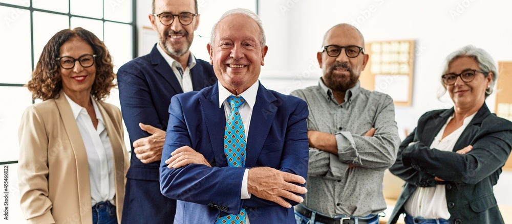 Group of middle age business workers smiling happy standing with arms crossed gesture at the office