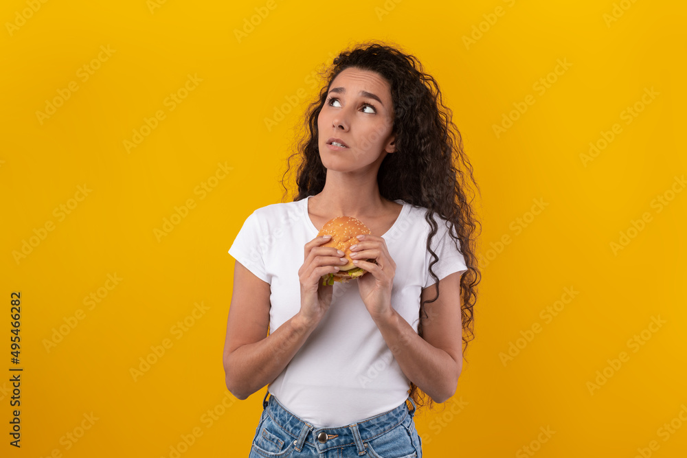 Sad Young Lady Holding Burger And Thinking Sad Young Lady Holding Burger And Thinking