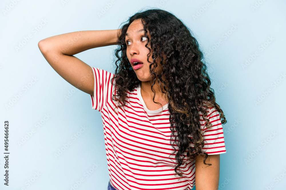 Young hispanic woman isolated on blue background being shocked, she has remembered important meeting. Young hispanic woman isolated on blue background being shocked, she has remembered important meeting.