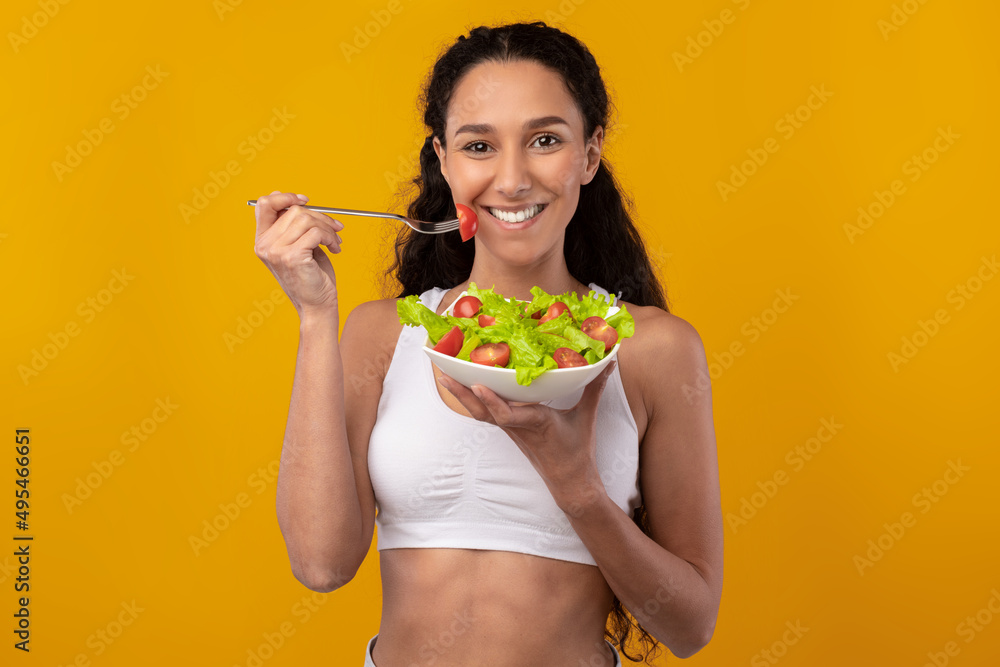 Portrait of Smiling Sporty Lady Holding Plate With Salad Portrait of Smiling Sporty Lady Holding Plate With Salad