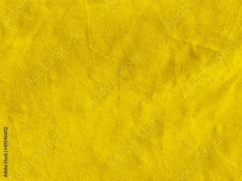 Yellow velvet fabric texture used as background. Empty yellow fabric background of soft and smooth textile material. There is space for text....