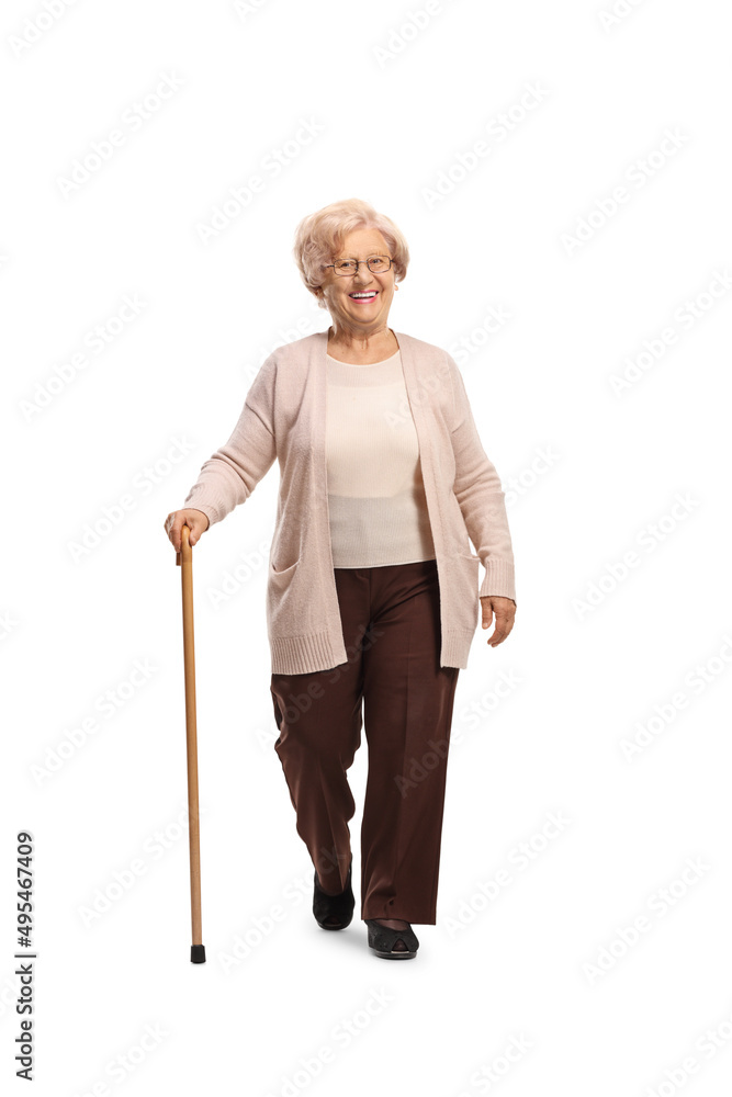 Smiling elderly woman walking towards camera with a cane Smiling elderly woman walking towards camera with a cane