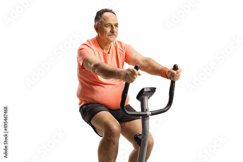 Mature man exercising on a stationary bike