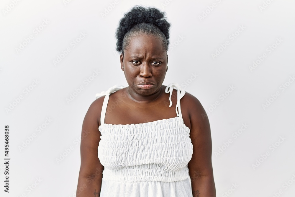 Young african woman standing over white isolated background depressed and worry for distress, crying angry and afraid. sad expression.