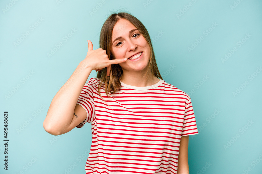Young caucasian woman isolated on blue background showing a mobile phone call gesture with fingers. Young caucasian woman isolated on blue background showing a mobile phone call gesture with fingers.