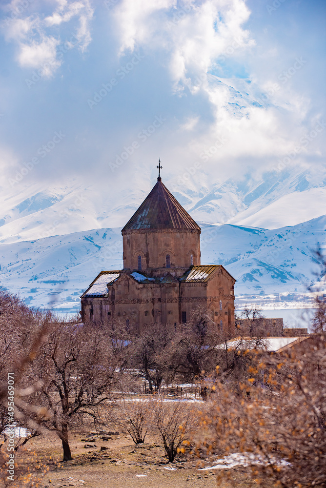 Akdamar Church. A church on the island, a historical building, a christian place of worship.snowy mountains in the background

