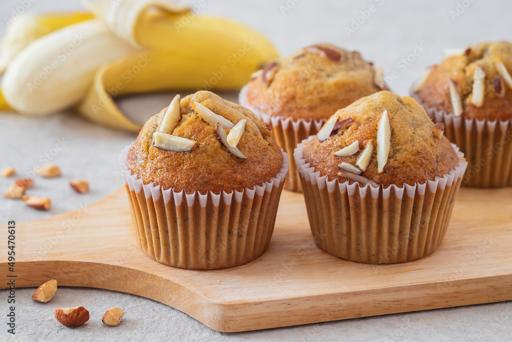 Banana muffins with almond on wooden board