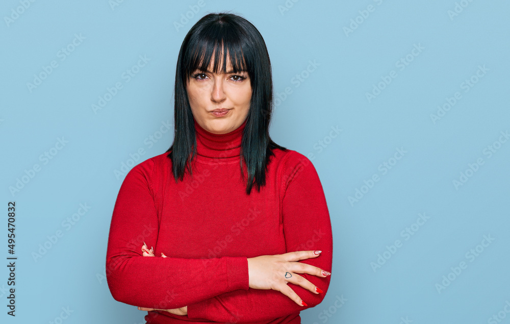 Young hispanic woman wearing casual clothes skeptic and nervous, disapproving expression on face with crossed arms. negative person. Young hispanic woman wearing casual clothes skeptic and nervous, disapproving expression on face with crossed arms. negative person.