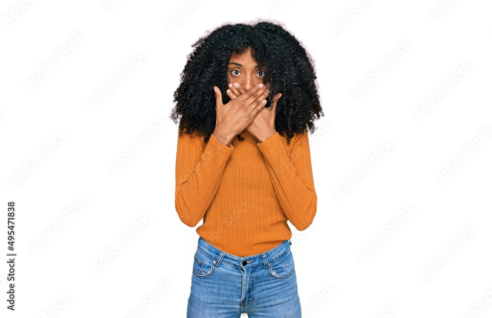 Young african american girl wearing casual clothes shocked covering mouth with hands for mistake. secret concept. Young african american girl wearing casual clothes shocked covering mouth with hands for mistake. secret concept.