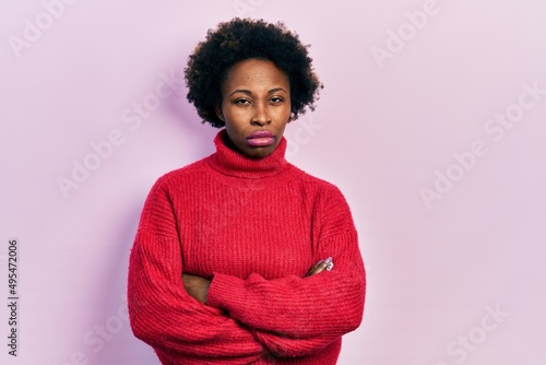 Fototapeta Young african american woman with arms crossed gesture skeptic and nervous, frowning upset because of problem