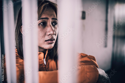 Portrait of women desperate to catch the iron prison,prisoner concept,thailand people,Hope to be free,If the violate the law would be arrested and jailed.