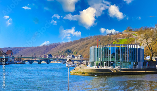 Namur, Belgium - March 9. 2022: View on confluence of river meuse and sambre with bridge, modern restaurant building, blue morning sky photo