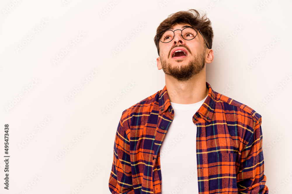 Young hispanic man isolated on white background shouting very angry, rage concept, frustrated. Young hispanic man isolated on white background shouting very angry, rage concept, frustrated.