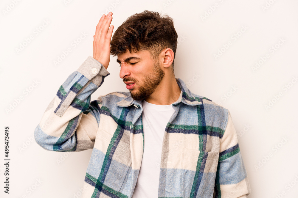 Young hispanic man isolated on white background forgetting something, slapping forehead with palm and closing eyes. Young hispanic man isolated on white background forgetting something, slapping forehead with palm and closing eyes.