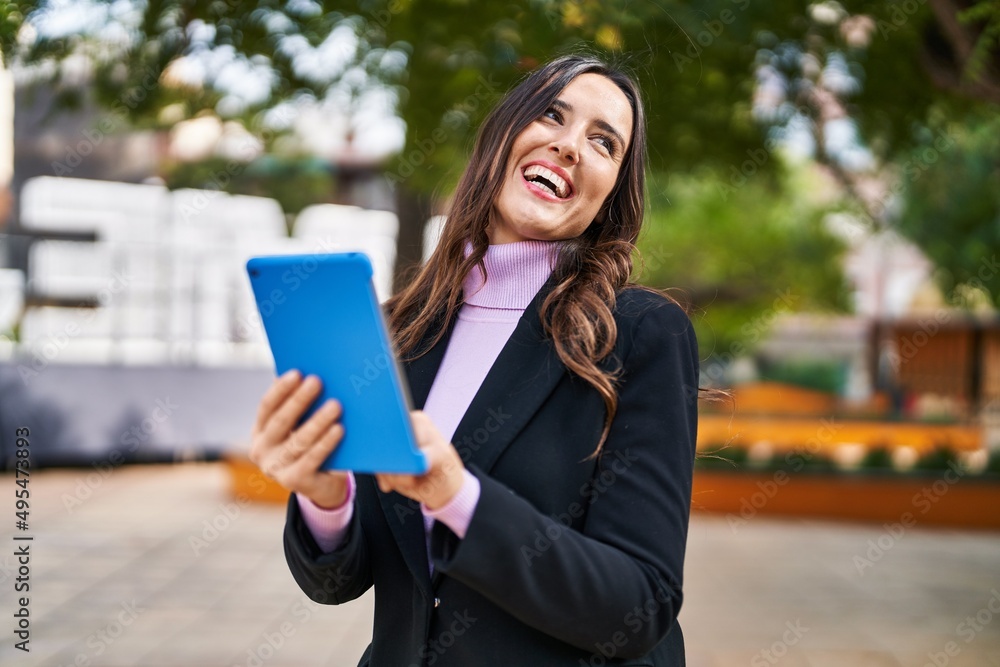 Young hispanic woman smiling confident using touchpad at park Young hispanic woman smiling confident using touchpad at park