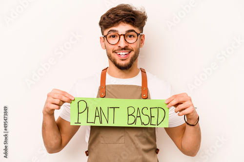 Young gardener man holding plant based placard isolated on white background photo