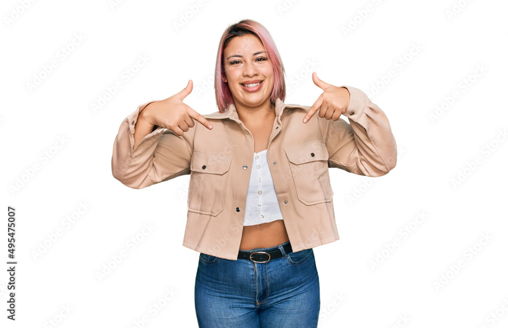 Hispanic woman with pink hair wearing casual clothes looking confident with smile on face, pointing oneself with fingers proud and happy. Hispanic woman with pink hair wearing casual clothes looking confident with smile on face, pointing oneself with fingers proud and happy.
