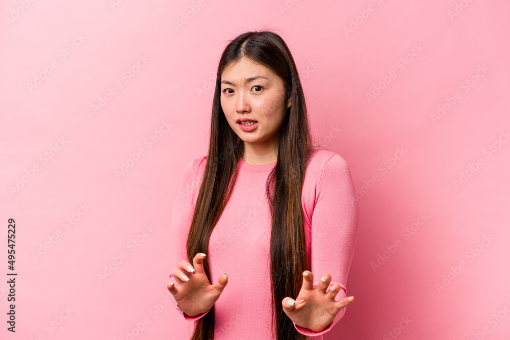Young Chinese woman isolated on pink background rejecting someone showing a gesture of disgust. Young Chinese woman isolated on pink background rejecting someone showing a gesture of disgust.