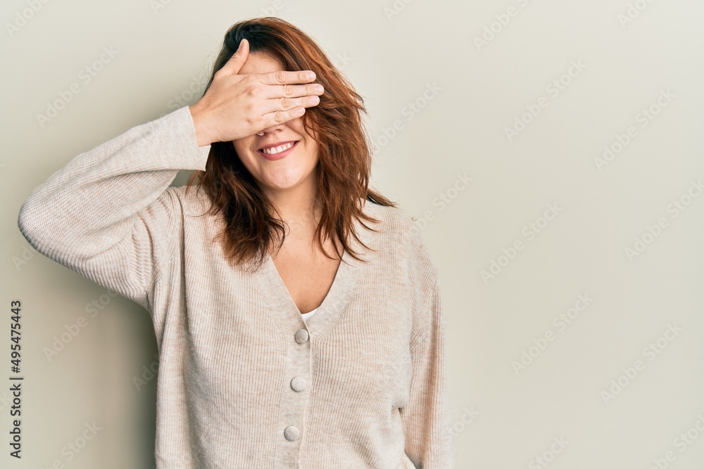 Young caucasian woman wearing casual clothes smiling and laughing with hand on face covering eyes for surprise. blind concept. Young caucasian woman wearing casual clothes smiling and laughing with hand on face covering eyes for surprise. blind concept.