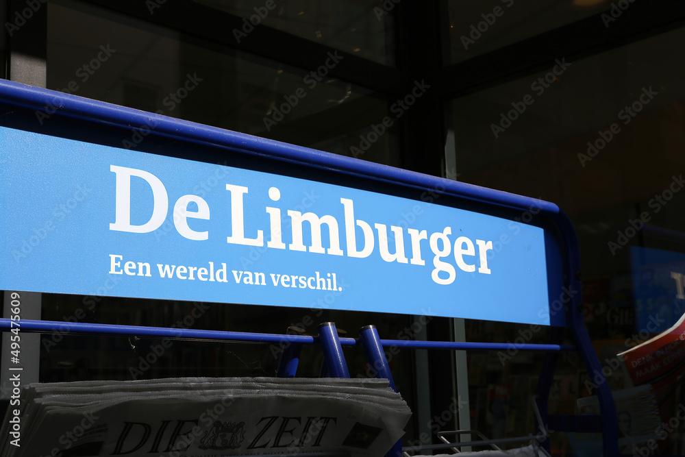 Obraz premium Sittard, Netherlands - March 25. 2022: Closeup of magazine rack with logo lettering of dutch daily newspaper de limburger