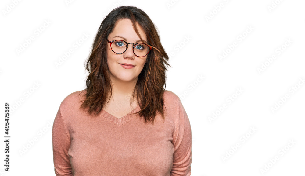 Young plus size woman wearing casual clothes and glasses relaxed with serious expression on face. simple and natural looking at the camera. Young plus size woman wearing casual clothes and glasses relaxed with serious expression on face. simple and natural looking at the camera.
