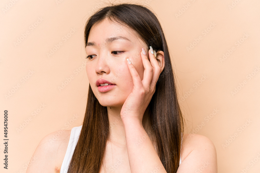 Young portrait asian woman isolated on beige background Young portrait asian woman isolated on beige background