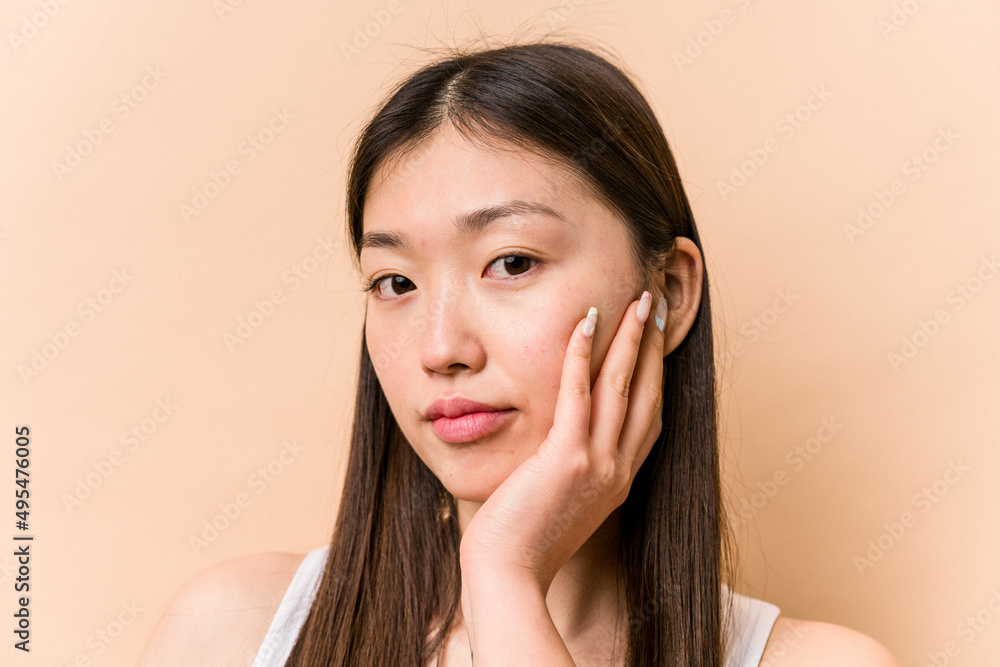 Young portrait asian woman isolated on beige background Young portrait asian woman isolated on beige background