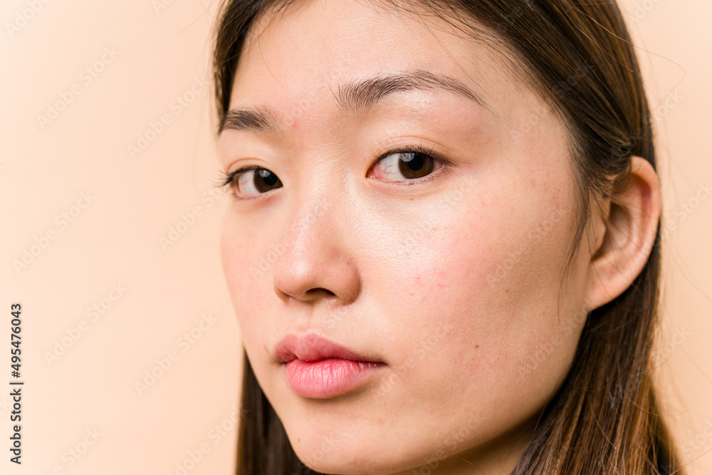 Fototapeta premium Young portrait asian woman isolated on beige background