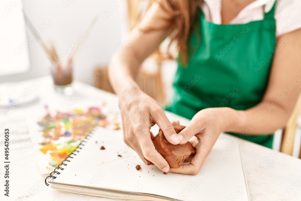 Obraz premium Middle age hispanic woman make ceramics at art studio