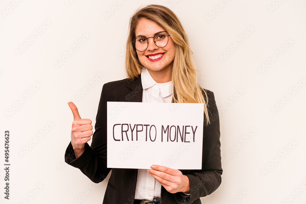 Young business caucasian woman holding a crypto money placard isolated on white background smiling and raising thumb up Young business caucasian woman holding a crypto money placard isolated on white background smiling and raising thumb up