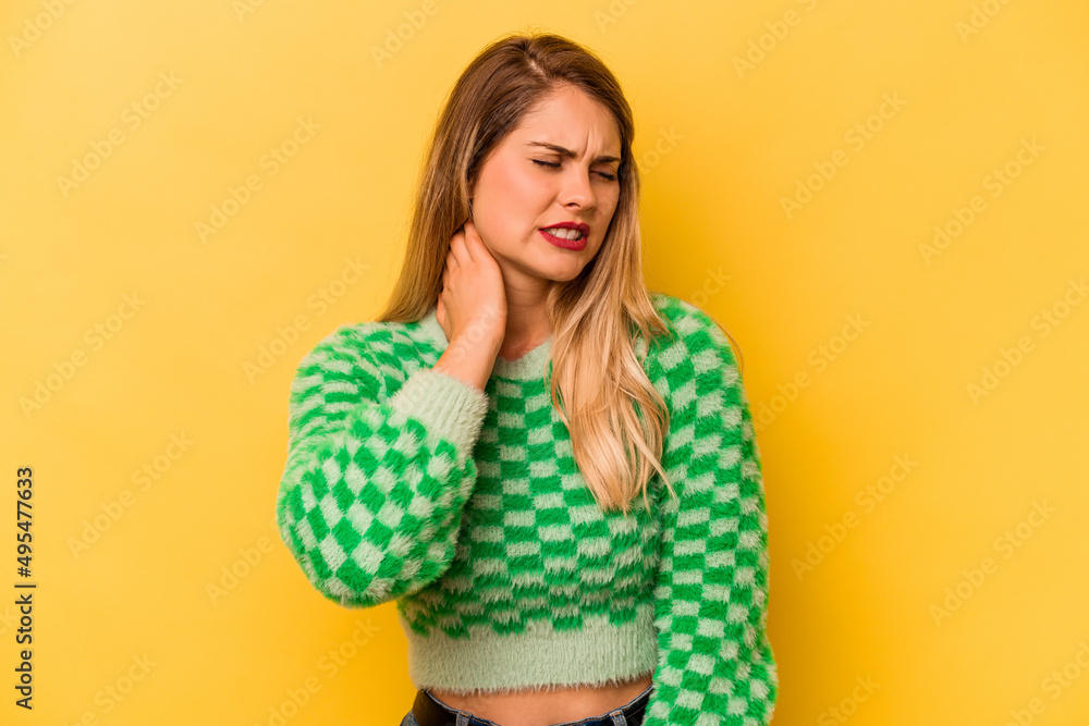 Young caucasian woman isolated on yellow background suffering neck pain due to sedentary lifestyle. Young caucasian woman isolated on yellow background suffering neck pain due to sedentary lifestyle.
