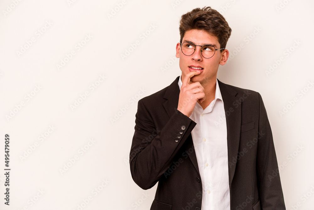 Young caucasian business man isolated on white background relaxed thinking about something looking at a copy space. Young caucasian business man isolated on white background relaxed thinking about something looking at a copy space.