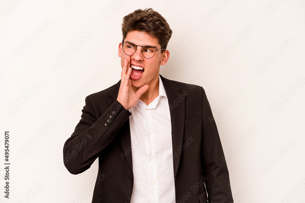 Young caucasian business man isolated on white background shouting and holding palm near opened mouth.
