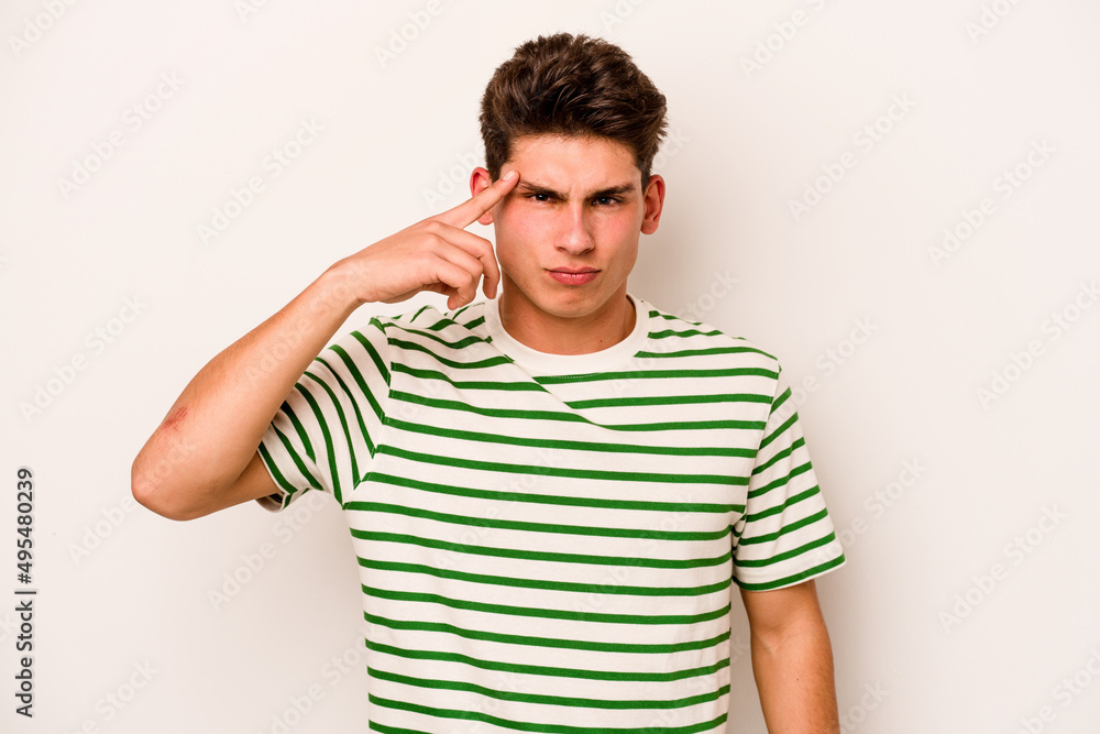 Young caucasian man isolated on white background pointing temple with finger, thinking, focused on a task. Young caucasian man isolated on white background pointing temple with finger, thinking, focused on a task.