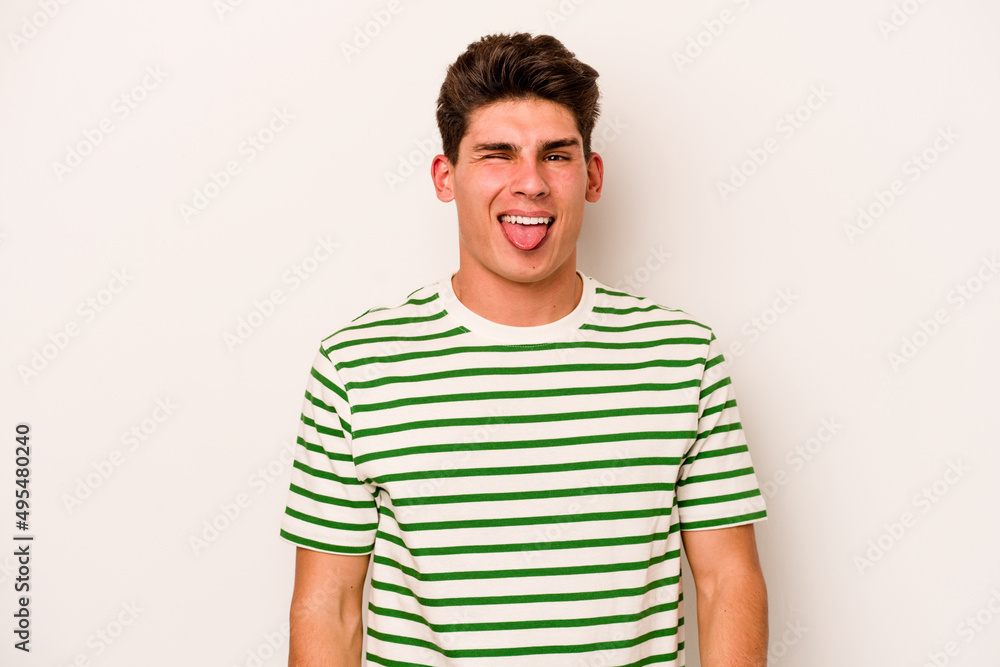 Young caucasian man isolated on white background funny and friendly sticking out tongue. Young caucasian man isolated on white background funny and friendly sticking out tongue.