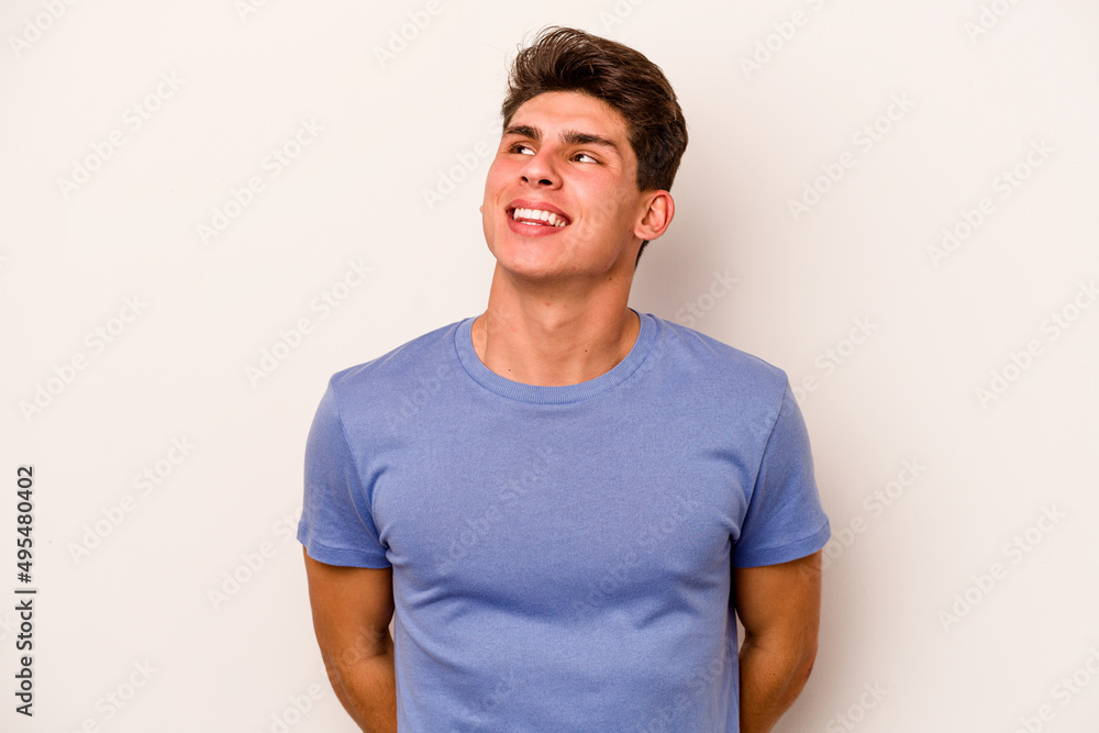Young caucasian man isolated on white background relaxed and happy laughing, neck stretched showing teeth. Young caucasian man isolated on white background relaxed and happy laughing, neck stretched showing teeth.