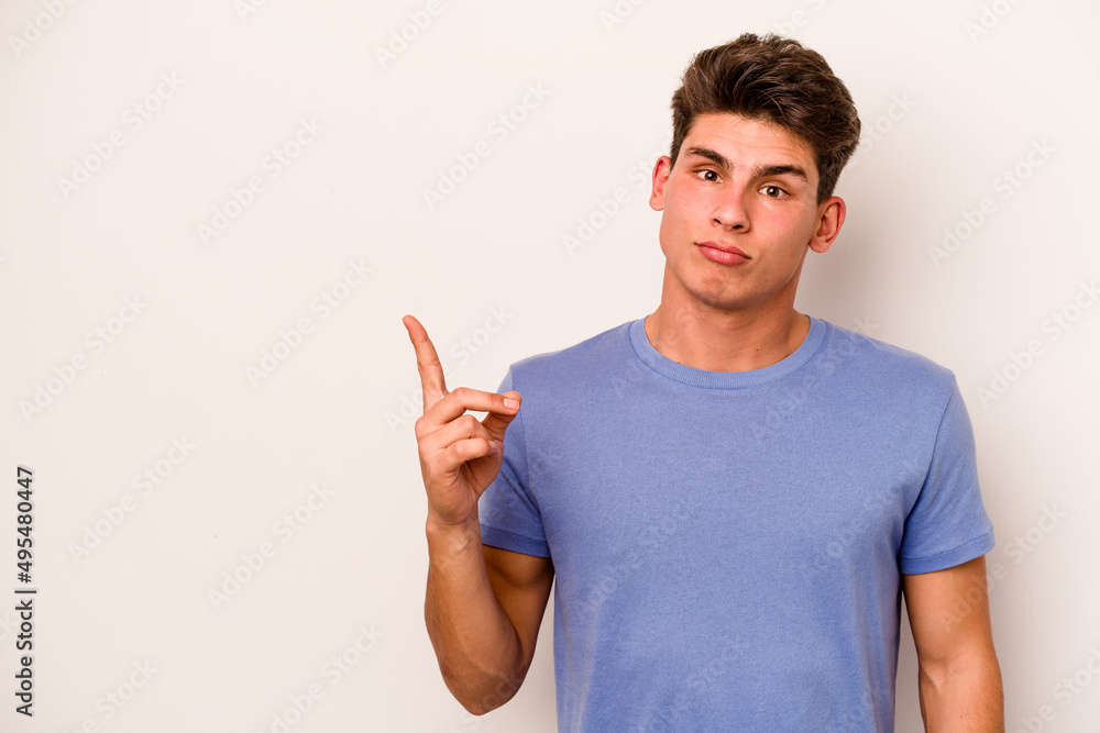 Young caucasian man isolated on white background showing number one with finger. Young caucasian man isolated on white background showing number one with finger.