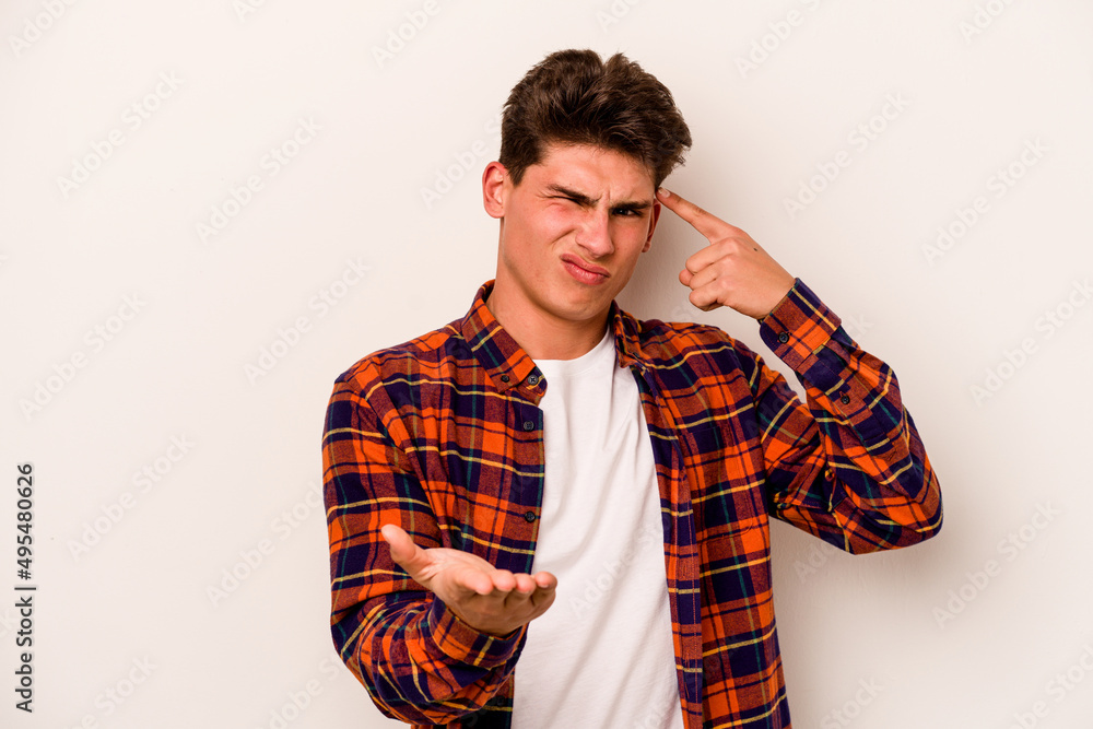 Fototapeta premium Young caucasian man isolated on white background holding and showing a product on hand.