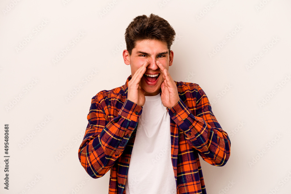 Young caucasian man isolated on white background saying a gossip, pointing to side reporting something. Young caucasian man isolated on white background saying a gossip, pointing to side reporting something.