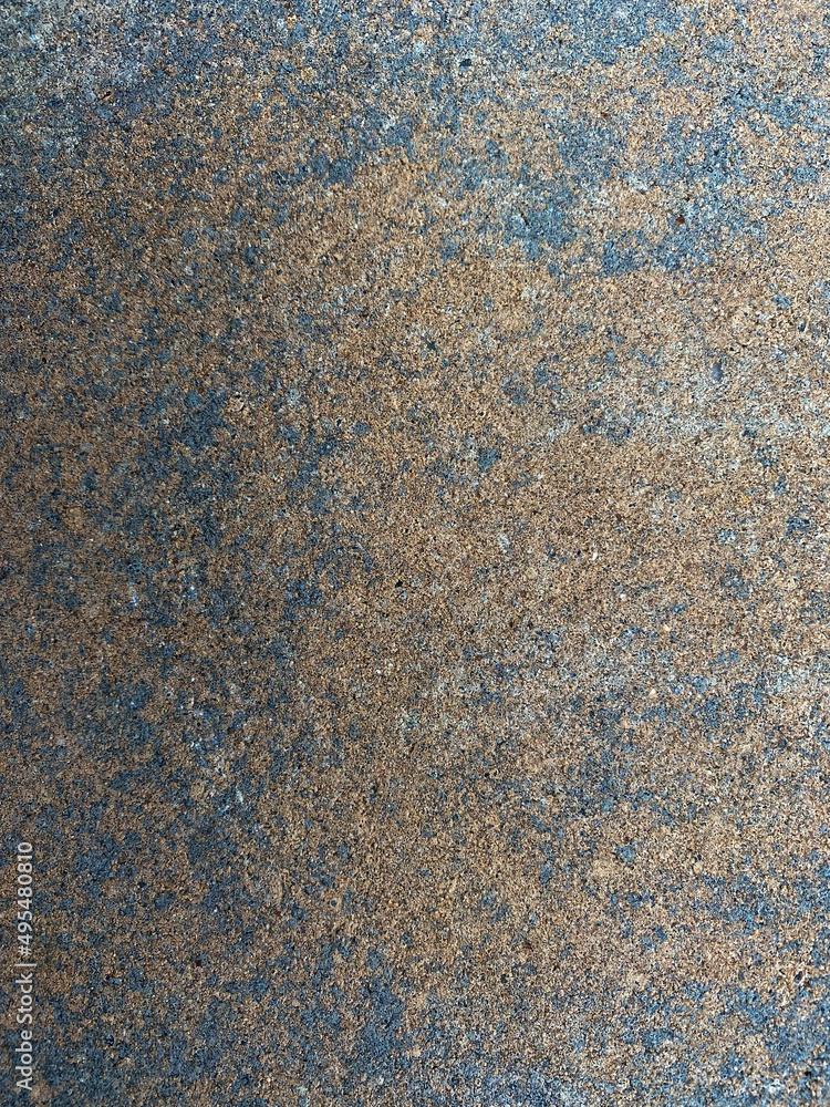 Fototapeta premium Multicolored Concrete rock from a retaining wall with grey, black, and orangish colors 