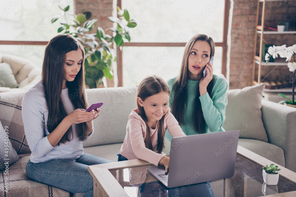Photo of three busy lovely ladies sitting divan room speak mobile browse laptop type sms cellphone indoors Photo of three busy lovely ladies sitting divan room speak mobile browse laptop type sms cellphone indoors