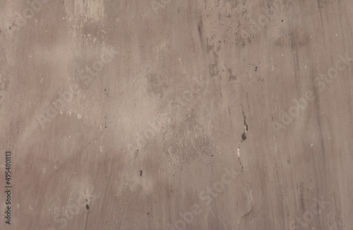 Plaster wall background with cracks in shades of grey. An old weathered wall with grunge texture.