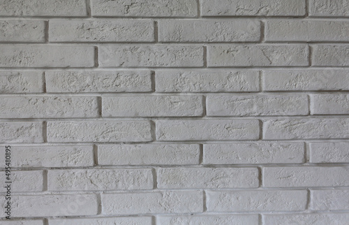 White decorative brick wall close up. Horizontal brick tile background. Scandinavian interior. Abstract texture.