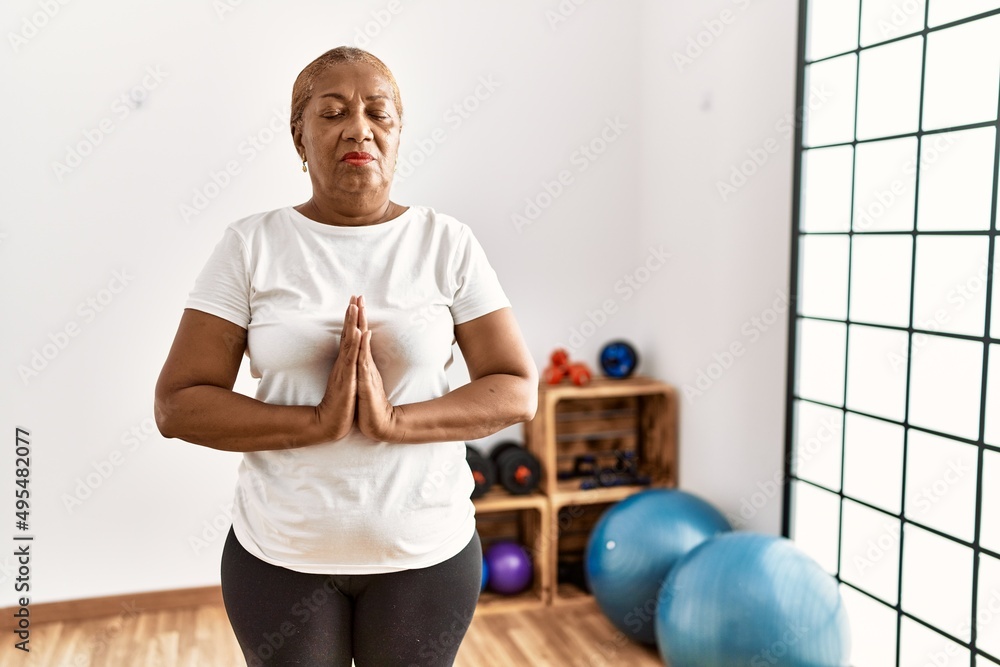 Senior african american woman training yoga at sport center Senior african american woman training yoga at sport center