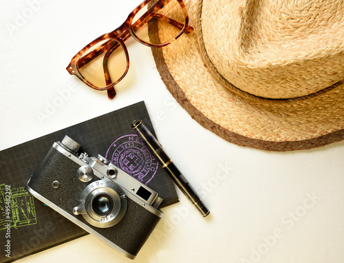 Vintage camera and travel accessories on white background flat lay photo