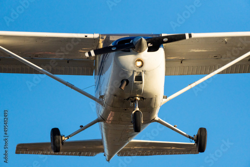 Small plane flying with sunset light in a clear sky before landing on Sabadell Airport. photo