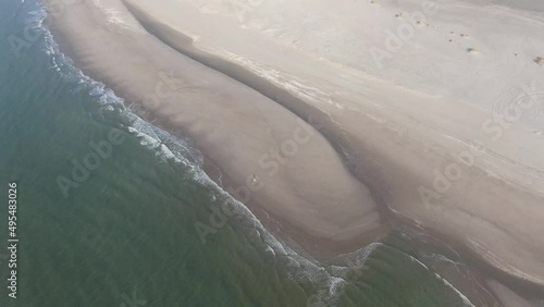 Aerial video of the dutch coastal defence project sand engine where natural forces divide sediment along the coast  photo